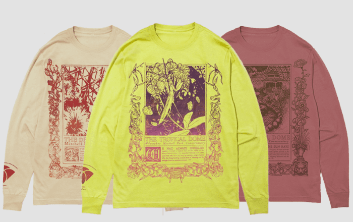 Three graphic t-shirts in tan, yellow, and mauve colors, each featuring a detailed botanical illustration and text about different domes: The Desert Dome, The Tropical Dome, and The Floral Dome.