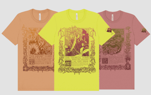 Three graphic t-shirts in tan, yellow, and mauve colors, each featuring a detailed botanical illustration and text about different domes: The Desert Dome, The Tropical Dome, and The Floral Dome.